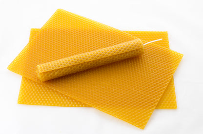 Example of beeswax sheets and a rolled beeswax candle made from them front view